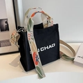 Black canvas bucket bag with floral patterned wide strap and J CHAO embroidery - Contrast Black