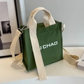 Dark green canvas bucket bag with wide cream shoulder strap and U CHAO letter print - Green