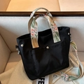 Black nylon tote bag with colorful floral wide straps and a silver metal snap pocket - Black