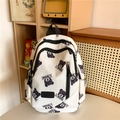 Quilted white backpack featuring a black bear print and spacious front zip pocket - Black