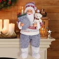 Detail of 12-inch sitting Santa Claus doll with knitted hat holding a small teddy bear - Sitting Santa Nordic Knit Sweater Style