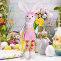 Detailed view of Easter bunny doll with beaded legs holding a yellow plush flower decoration - Female Style