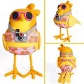 Detail view of a yellow felt bird ornament wearing pink sunglasses and floral swimwear - Camera Bird
