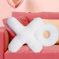 Detalle de cojín decorativo blanco con forma de XO hecho de suave felpa de peluche - Cojín XO / Blanco