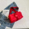 Red nylon crossbody bag with adjustable wide strap and buckle closure on denim jacket - Small / Red