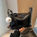 Chic black bucket bag in wrinkled patent leather with a white fuzzy monster charm - Black