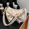 Chic cream-white bow shoulder bag featuring decorative pearl chain and leather strap - White