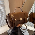 Vintage brown leather crossbody bag with golden twist lock and adjustable shoulder strap - Brown
