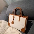 Borsa tote bianca effetto coccodrillo con manici in pelle marrone su divano - Bianco e Marrone