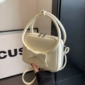 Chic cream white handbag with large bow detail and circular rigid top handle - Off White