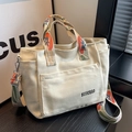 Cream canvas tote bag featuring floral pattern wide shoulder strap and front pocket - Off White