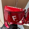Red semicircular crossbody saddle bag with white lettering and wide patterned strap - Red