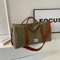 Olive green large canvas travel bag with brown leather accents and adjustable strap - Green