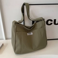 Army green canvas tote bag with adjustable shoulder strap and fashion label detail - Green