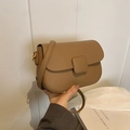 Chic khaki pebbled leather saddle bag with adjustable strap and vintage buckle detail - Khaki