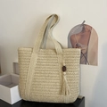 Beige woven straw tote bag with tassel charm for summer beach vacation use - Off White