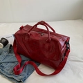 Large red glossy travel duffel bag with shoulder strap and side zipper pocket - Red