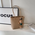 Beige tote bag with litchi texture featuring a cute rabbit charm and long shoulder straps - Light Khaki