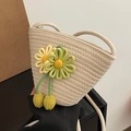 Cream woven bucket bag featuring yellow and green flower charms and thin rope strap - Off White