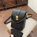 Crossbody phone bag in black embossed leather with gold hardware and top handle - Black