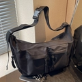 Versatile black canvas messenger bag with large capacity and woven zipper details - Black
