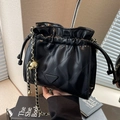Quilted black drawstring bucket bag with gold chain strap and triangle detail - Black