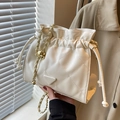 Quilted bucket bag in cream with gold chain strap and metal ball detail - Off-white