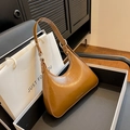 Chic brown glossy leather hobo bag with silver zipper in a luxury gift box setting - Brown