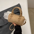 Khaki suede mini Boston bag with dual handles and gold zippers on grey blazer background - Khaki No Pendant