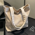 Beige canvas tote bag with 'on the book' gold embroidery for daily commuting - Off-white