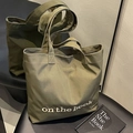 Olive green canvas tote bag with book embroidery and spacious interior for daily commute - Green
