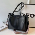Large black tote bag with wide geometric patterned strap and sleek leather finish - Black
