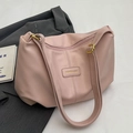 Dusty pink pleated tote bag with gold hardware and fashion tag on grey blazer - Pink Without Charm
