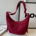 Burgundy crescent nylon crossbody bag with adjustable strap and decorative knot zipper - Red
