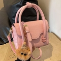 Pink croc-embossed small square bag with cute brown teddy bear pendant and top handles - Pink