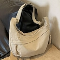 Adjustable beige nylon crescent shoulder bag with wide strap and woven charm detail - Off White