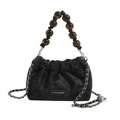 Black velvet drawstring bucket bag featuring amber bead handle and silver chain strap - Black