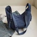 Dark blue nylon crescent crossbody bag with woven knot detail in casual utility style - Blue