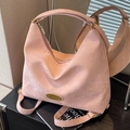 Pink suede multi-way hobo bag with gold hardware shown as a backpack and handbag - Pink