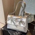 Silver metallic pleated crossbody bag featuring dual bow accents and shoulder straps - Silver