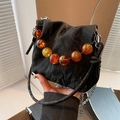 Black pleated bucket bag with amber bead handle and silver metal chain strap - Black