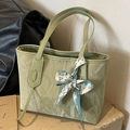 Light green textured nylon tote bag with decorative scarf on stone surface - Green
