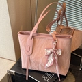 Pink tote bag with pleated texture and stylish silk scarf on a reflective surface - Pink