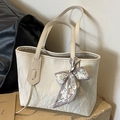 Cream tote bag with pleated leather texture and decorative scarf on stone base - Off White