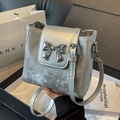 Silver metallic bucket bag for women with sparkling texture and large bow hardware - Silver