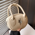 Elegant cream-colored handheld bag featuring a unique silver metallic logo and dual handles - White