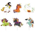 Macro view of six Halloween cartoon unicorn cake toppers featuring witch and pumpkin themes - Unicorn Design