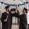 Blue glitter Congrats Grad banner with cap icons shown with graduates in background - Blue congrats grad