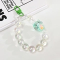 Detail of green acrylic cat charm and iridescent beads on a mobile phone chain strap - Green