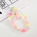 Detailed view of a cute mermaid bead charm with iridescent pearls and acrylic pendant - White